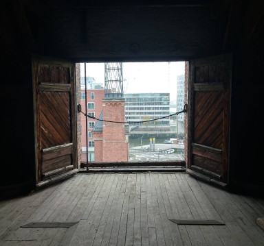 View through an opened wing door to the houses on the other side of the street
