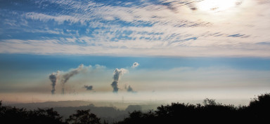Blue sky with smoke in the distance