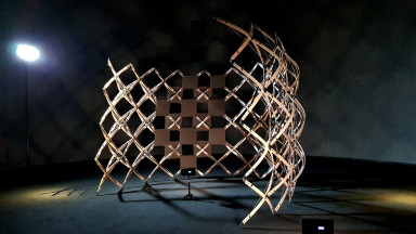 Exhibition view, spotlighted lightweight structure in dark room